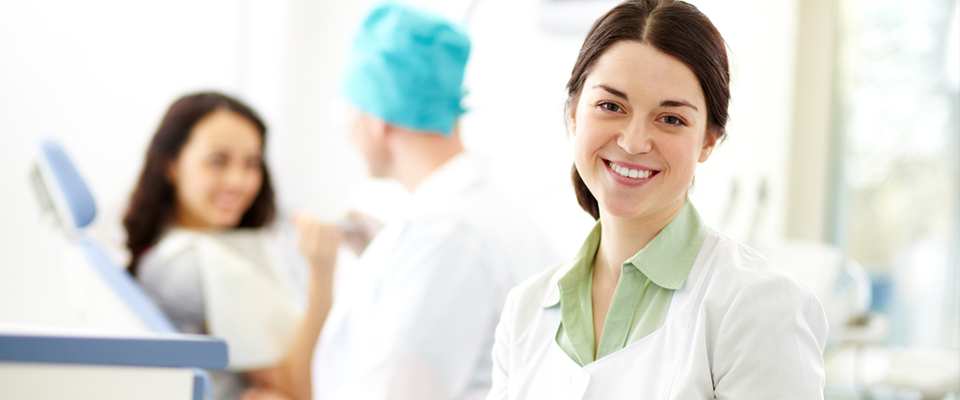 Smiling receptionist sitting at a desk